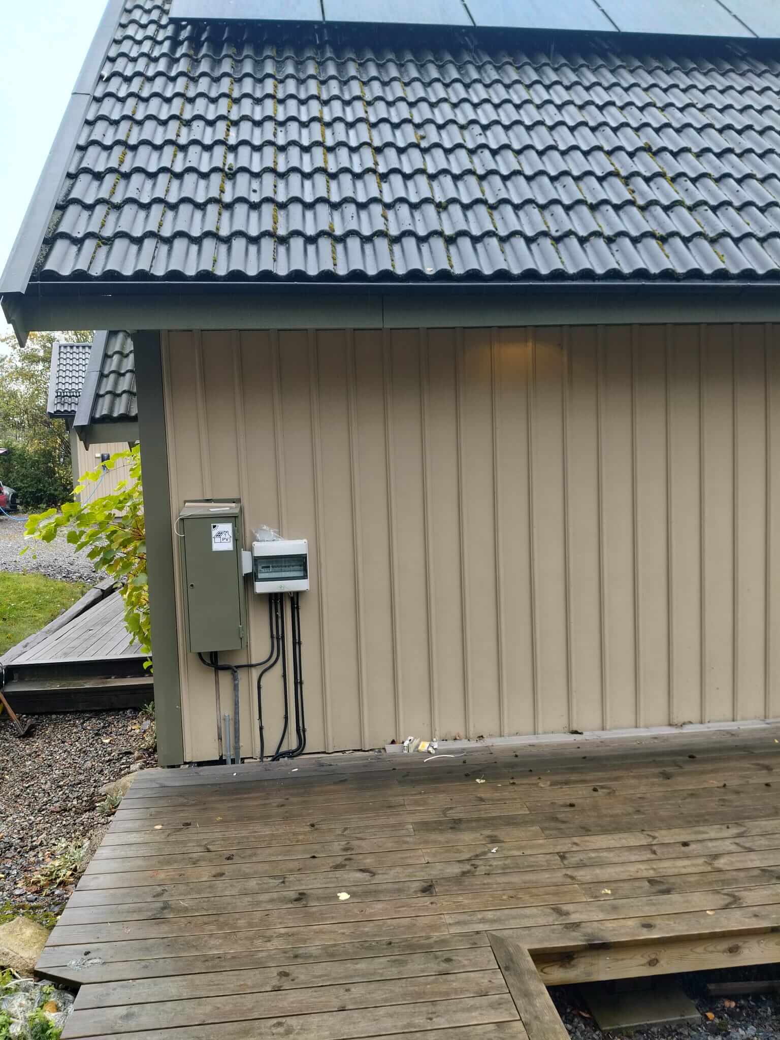 Prydlig kabelförläggning och kapsling för solcellsanläggning på träfasad i Tullinge
